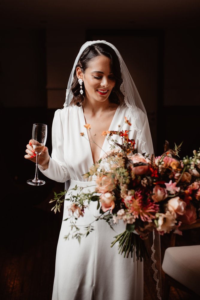 Alexandra in a plain crepe gown, the lace edge of her Ada veil running round her face