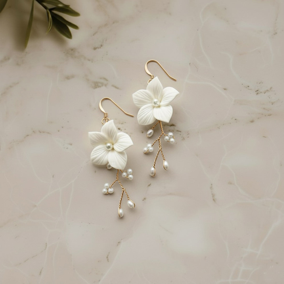 Handcrafted white floral and pearl bridal earrings — Hazel design by Britten Weddings.
