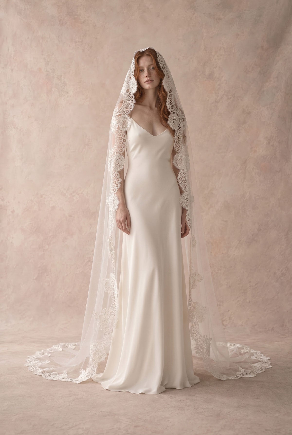 Bride wearing the Valentina lace mantilla veil at the crown, with floral lace framing her face
