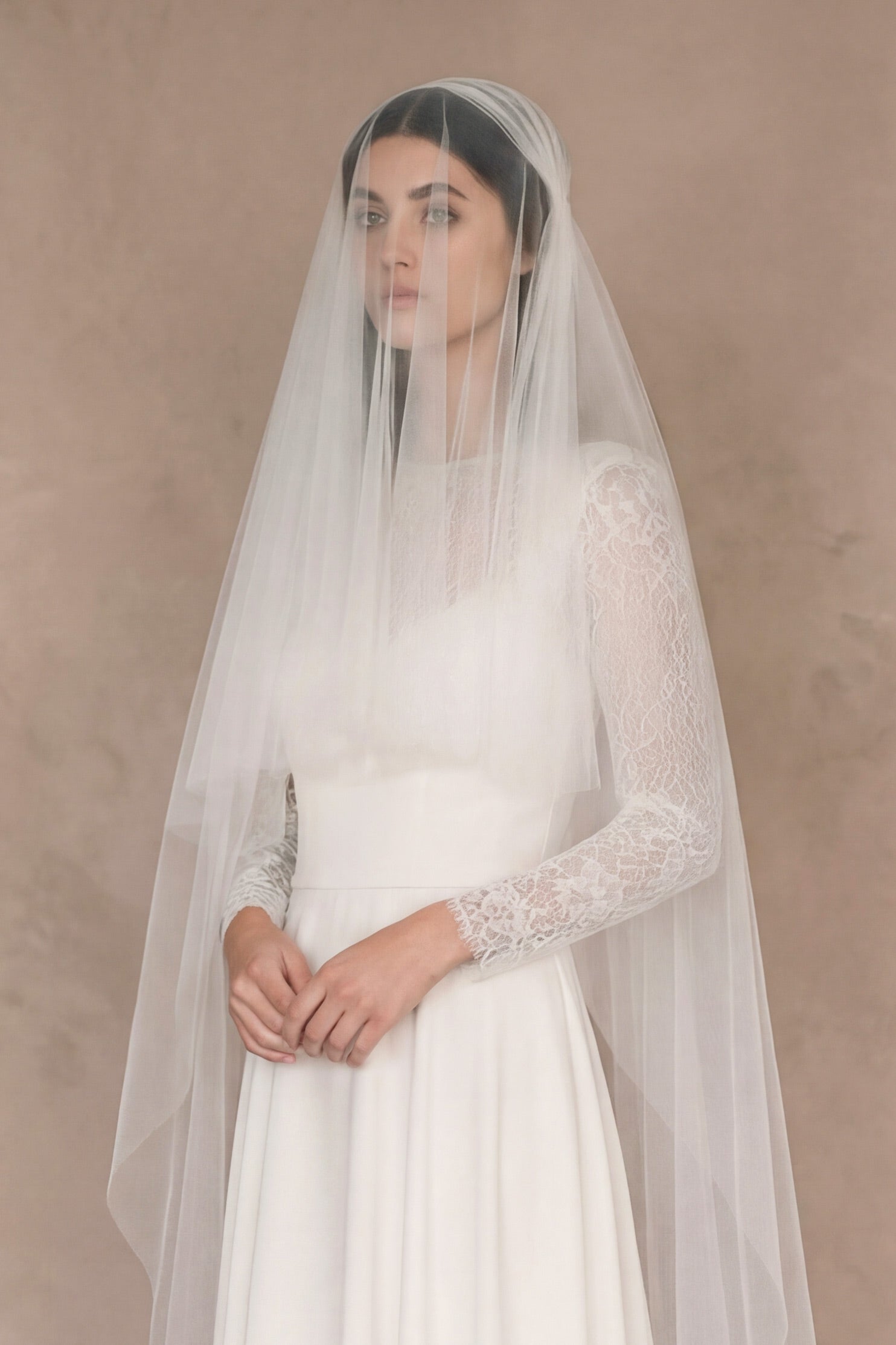 Close up of bride with the blusher layer of a Juliet cap veil worn over the face, creating a vintage 1920s look