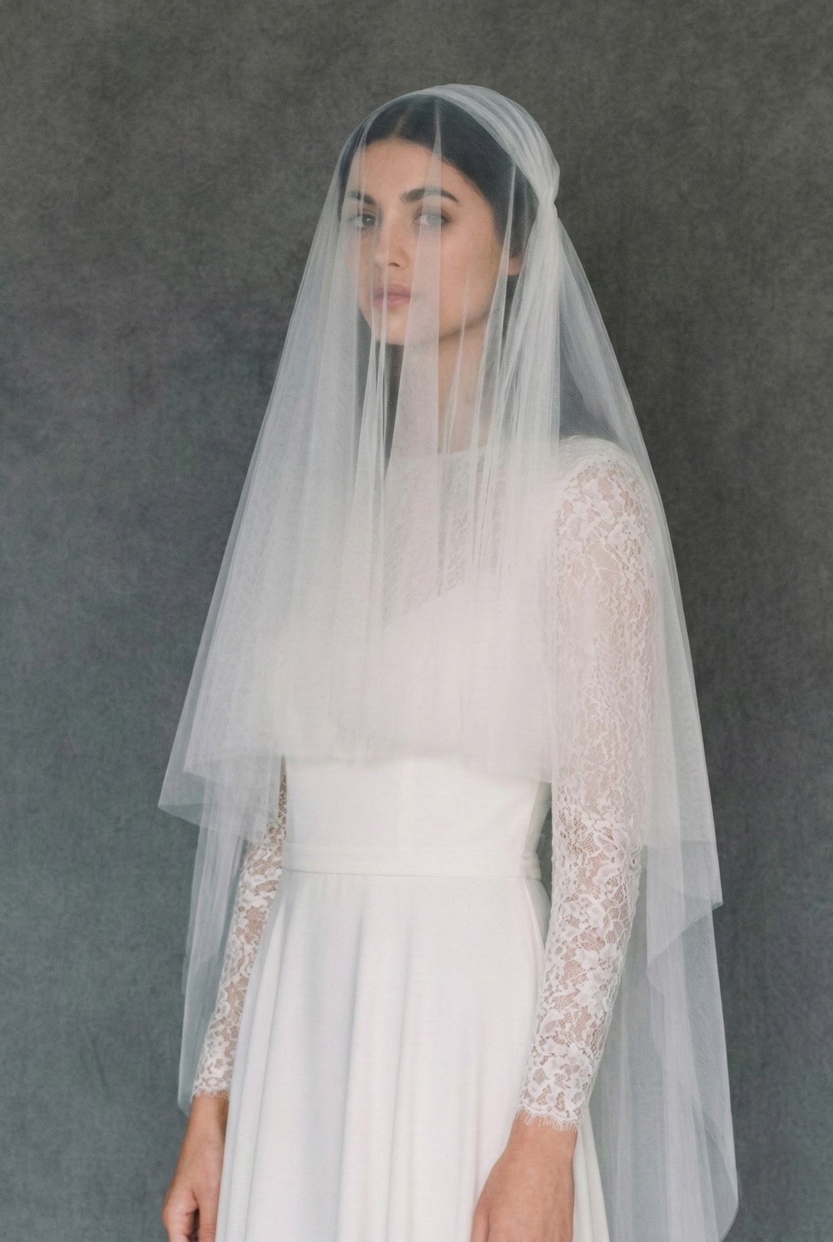 Close up of bride with the blusher layer of a Juliet cap veil worn over the face, creating a vintage 1920s look