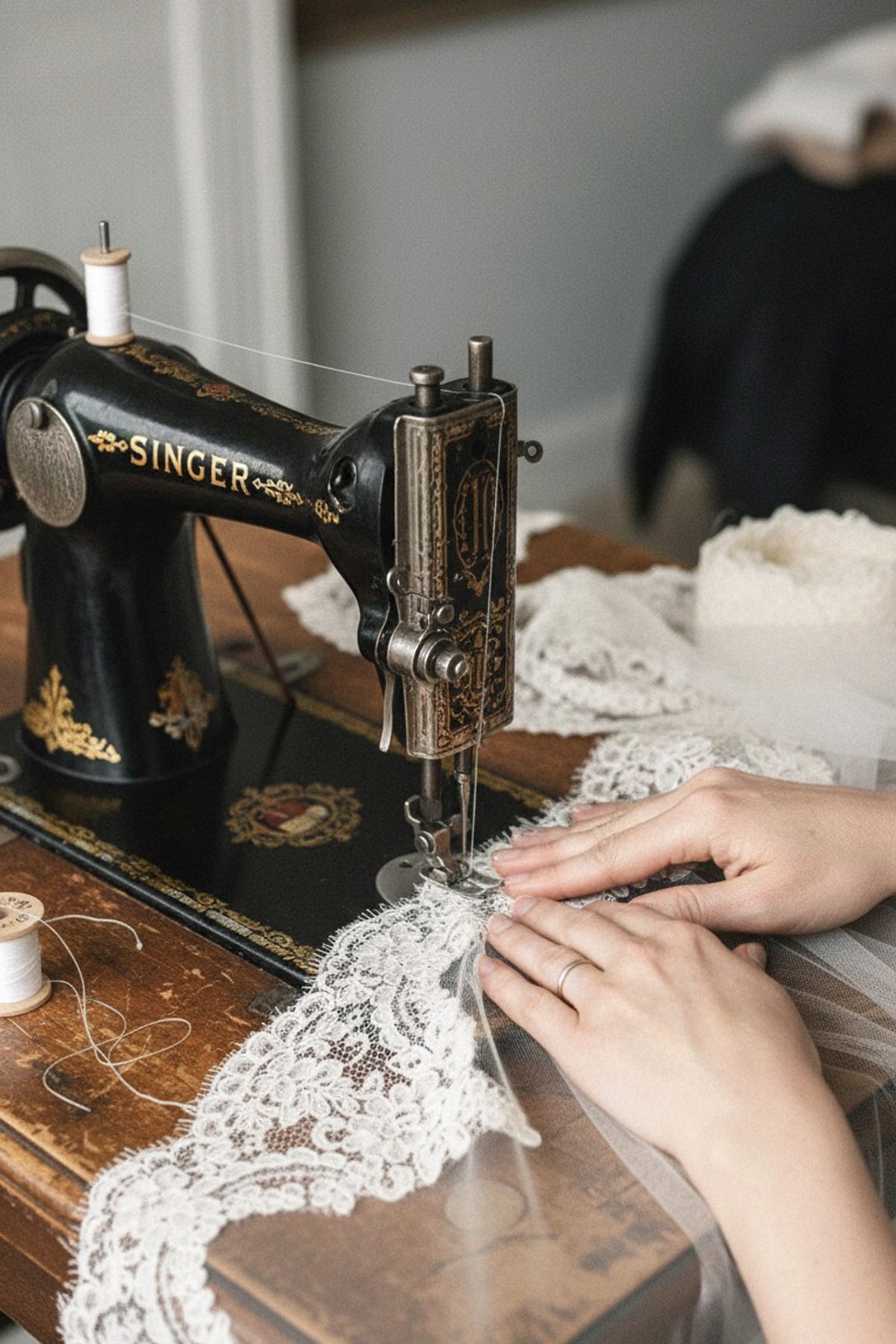 Handmade lace mantilla veil being crafted on a vintage Singer sewing machine at Britten Weddings, England