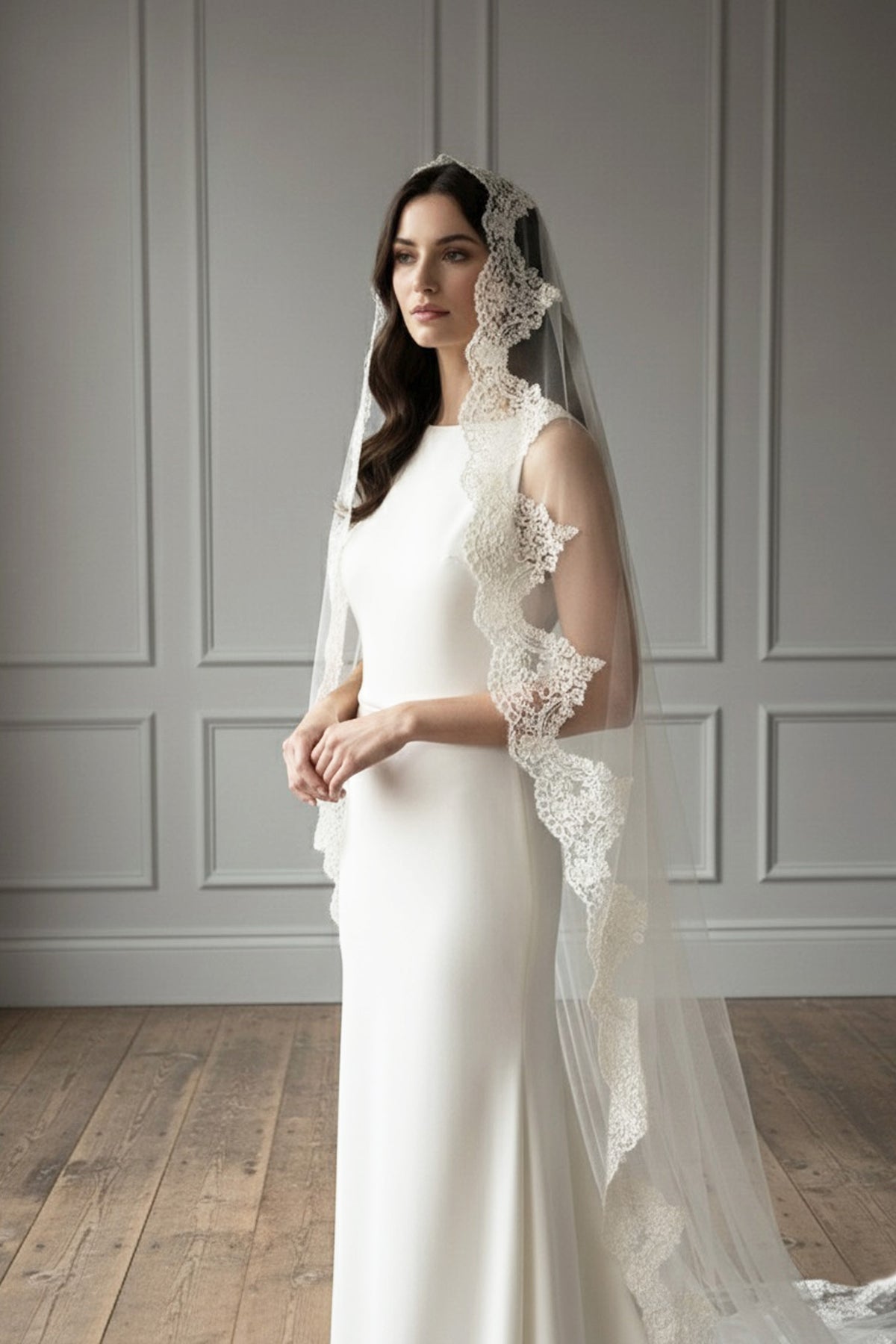 Bride wearing the Adela lace mantilla veil by Britten Weddings, a handmade Spanish-style wedding veil with scalloped lace edging