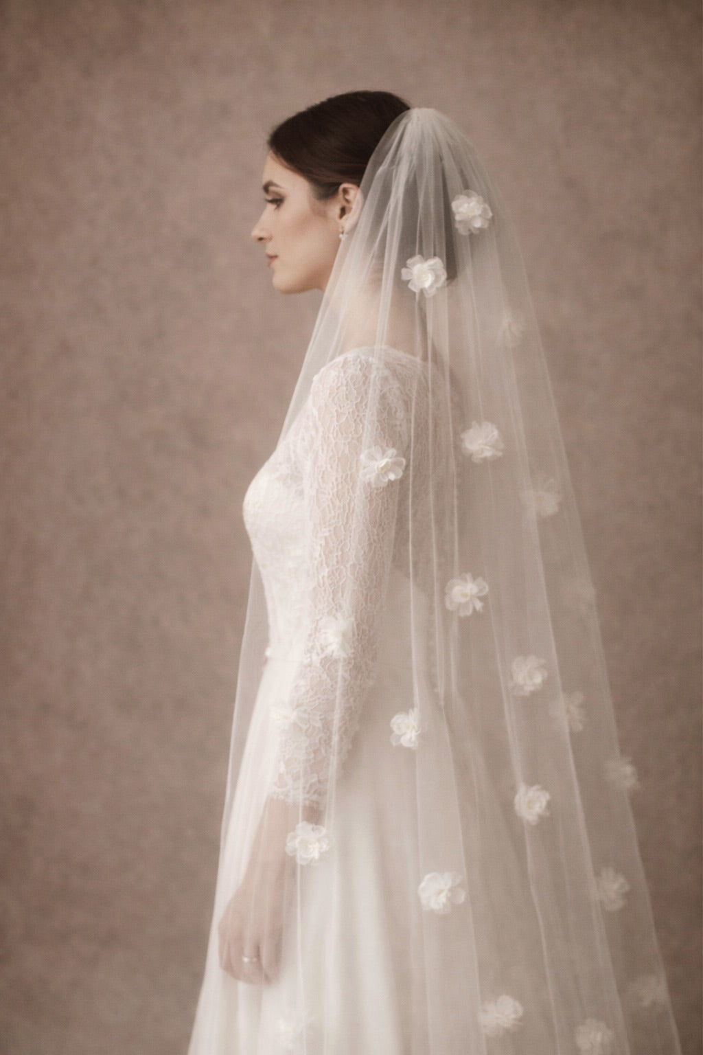 Petal Drift bridal veil in off-white traditional tulle featuring 3D handmade floral petals and a cut edge finish