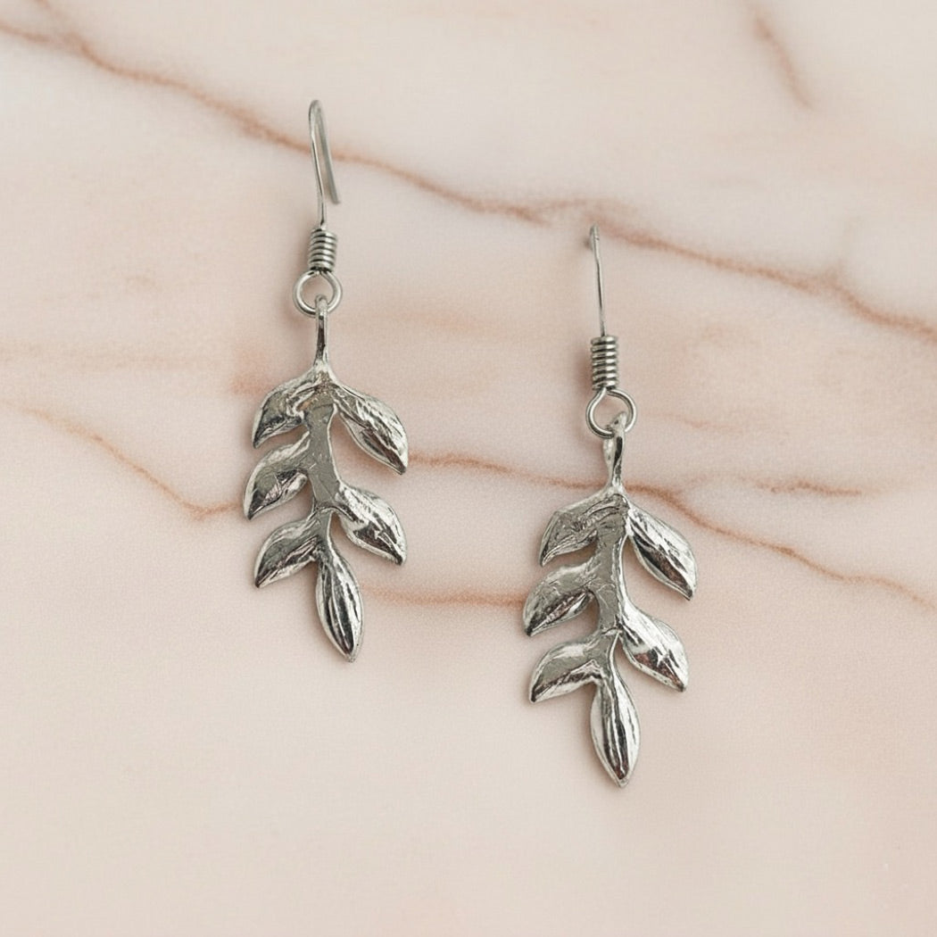 Delicate silver drop earrings with a handcrafted leaf design, perfect for brides or bridesmaids by Britten Weddings.