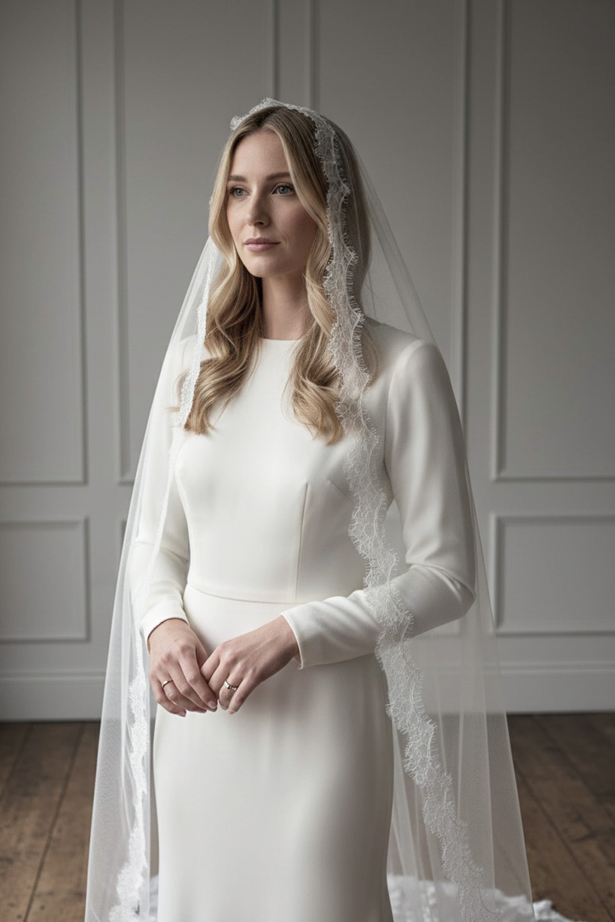 Bride wearing a Spanish-inspired mantilla veil handmade from silk-style tulle and finished with fine French eyelash lace by Britten Weddings