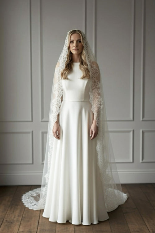 mantilla veil framing the face with wide eyelash lace, soft oval drape