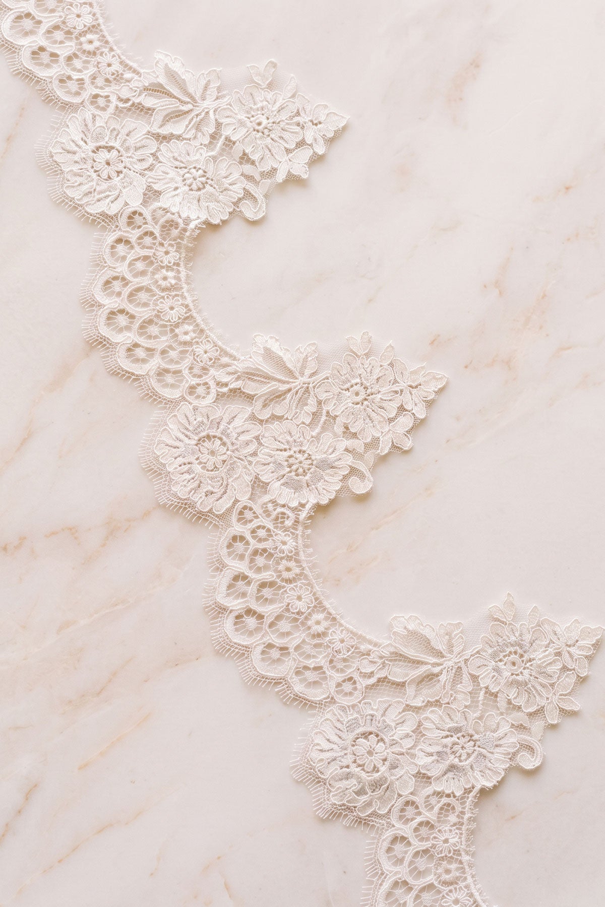 Valentina floral lace mantilla veil laid flat, showing the guipure lace edge