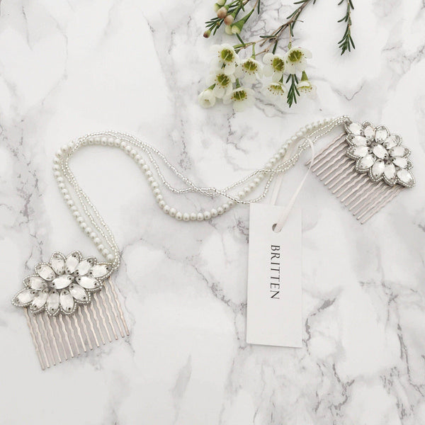 Bride wearing Britten Weddings crystal hair comb positioned elegantly in low chignon updo