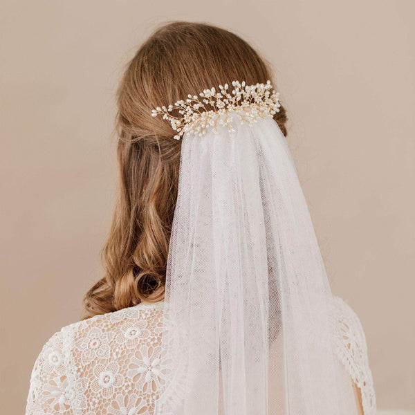 Bride wearing Britten Weddings delicate crystal headband with soft waves and hair down