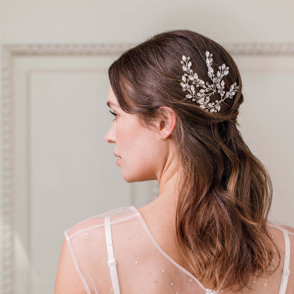 Set of Britten Weddings pearl hair pins scattered through bride's romantic updo