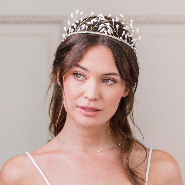 Bride wearing Britten Weddings crystal and pearl bridal crown with soft half-up hairstyle
