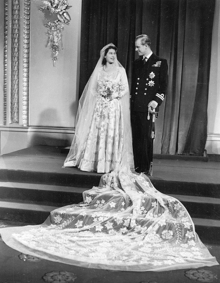 Princess Elizabeth in her 1947 wedding portrait, silk tulle veil and embroidered train spread across the steps